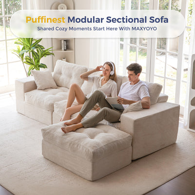 Two people sitting on a beige modular sectional sofa in a bright living room.