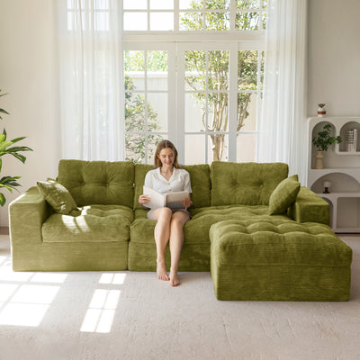 Woman sitting on a green sofa in a bright living room