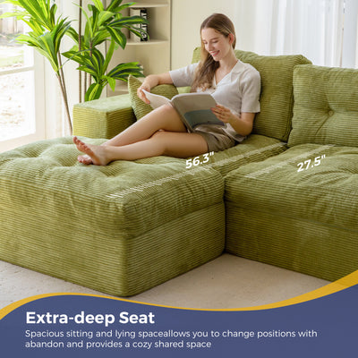 Woman sitting on a green sectional sofa with measurements highlighted, in a bright living room.